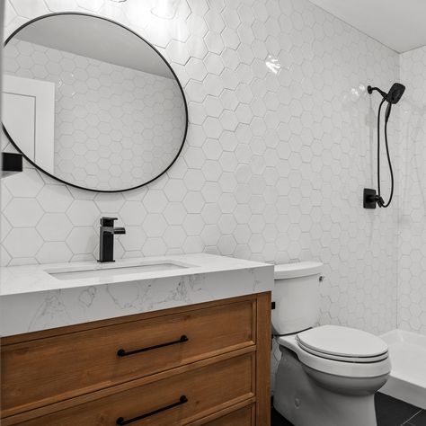 Get ready to add a touch of luxury to your daily routine. We absolutely love the transformation of this bathroom, from the beautiful white tile or that spa-like vibe to the wood vanity and black matte-framed mirror. Every detail counts, and we never leave a detail unturned! Call us for a consultation at(631)626-4005! #construction #homerenovation #homedesign #longislandcontractor #longislandconstruction #homerenovation #bathroomremodel #bathroomrenovation Hampton Homes, New Hampton, Wood Vanity, Framed Mirror, White Tiles, Black Matte, Bathroom Renovation, Daily Routine, Home Renovation