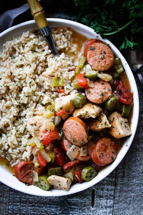 Chicken and Sausage Gumbo is a quick and delicious recipe that's loaded with chicken, sausage, and veggies. Served over brown rice, this easy gumbo is a one pot meal that's both healthy and filling! #chickenandsausagegumbo #chicienandsausagegumborecipes #gumbowithchickenandsausage #easygumborecipe Gumbo With Okra, Easy Gumbo, Gumbo Recipe Easy, Healthy Hearty Meals, Chicken And Sausage Gumbo, Chicken Sausage Gumbo, Gumbo Recipe Sausage, Chicken And Sausage, Sausage Gumbo