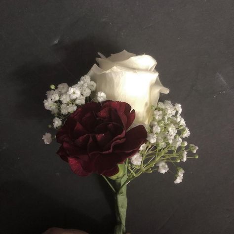 Groom's boutonniere with a white rose, burgundy mini carnation and baby's breath Burgundy Boutonniere Wedding, Burgundy Carnation Boutonniere, Wedding Boutineers Burgundy, Burgundy White Bouquet, Burgundy And White Boutonniere, Burgundy Wedding Boutonniere, Burgundy Rose Boutonniere, Burgandy Boutinere Ideas Groomsmen, Burgundy And White Flowers