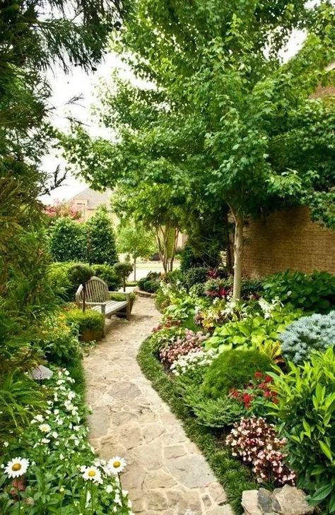 a gorgeous blooming side yard with lots of greenery and various flowers, a tree and a wooden bench feels like a secret garden Side Yard Kitchen Garden, Fairy Path, Yard Decor Ideas, Side Yard Garden, Designing A Garden, Japanese Inspired Garden, Stone Pavement, Concrete Path, Brick Path