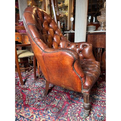 Stunning antique English library chair with gorgeous deep tufted leather, beautiful wooden legs with brass casters and antique nails. This chair has a stunning patina and will be the statement of any room!  Measuring 27" Wide x 27" Deep x 40" Tall Antique Reading Chair, Antique Barber Chair, Antique Chair Styles, Antique Nails, 1920s Home Decor, Cozy Town, African Interior Design, English Library, Vintage Home Office