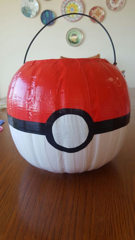 Pokeball halloween bucket made out of  a $1 pumpkin pail and duck tape Made by Delilah M Pokemon Diy Halloween, Pokeball Pumpkin Painting, Pokeball Pumpkin, Pokeball Halloween Bucket, Eevee Costume, Pokeball Pinata Diy, Pokeball Pinata, Halloween Pokemon, Random Holidays