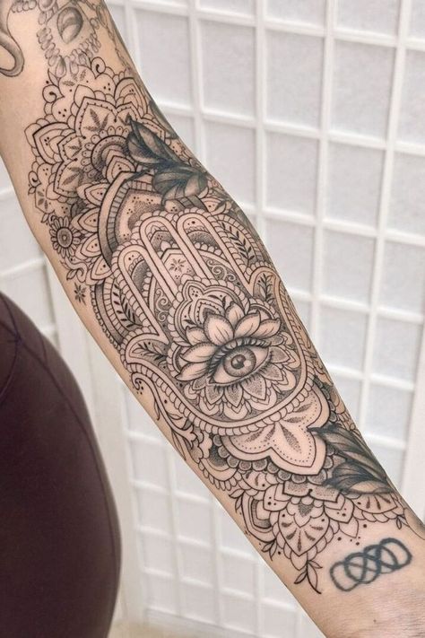 "These 12 beautiful tattoo ideas are perfect for women who want to express their individuality with unique, meaningful ink that stands the test of time." Hamza Hand Tattoo Design, Hamsa Hand Tattoo For Women, Hasma Tattoos For Women, Ahimsa Tattoo, Hasma Tattoo, Hamsa Tattoos, Fatima Hand Tattoo, Tattoo Ideas For Woman, Hamsa Hand Tattoo