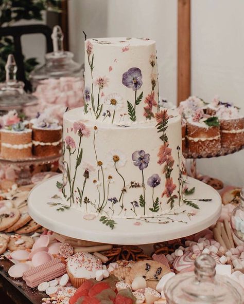 This wedding dessert table is quite literally covered in sweets! From wedding cupcakes to mini wedding cakes and a pretty floral pressed wedding cake in the center to top it all off. The pastel hues makes this such a playful idea for a boho spring wedding. Click to see more fun dessert bars! // Photo: Anne Schwarz, Florals: Maddocks Farm Organics, and Desserts: Blushing Cook Pressed Flower Cake, Tårta Design, Perfect Wedding Cake, Dessert Bar Wedding, Floral Wedding Cake, Dream Wedding Cake, Wedding Dessert Table, Wedding Stylist, Wedding Cakes With Flowers