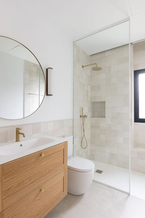 a neutral and airy Scandinavian bathroom with neutral tiles, a stained vanity, a shower space, a round mirror and brass fixtures Wallpapers For Bathrooms, Wallpapers For Walls, Desain Pantry, Scandinavian Bathroom, Bathroom Redesign, Bathroom Inspiration Decor, Apartment Bathroom, Small Bathroom Design, Bathroom Renos