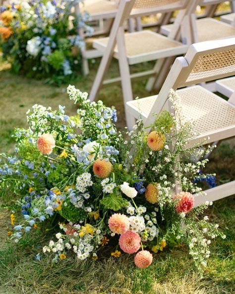 Beautiful blue, yellow, pink, and white flower arrangements lining the end of the wedding ceremony aisle. Floor Meadow Wedding, Wedding Aisle Garden, Flower Lined Aisle Wedding, Flower Lined Aisle, Aisle Meadow, Wedding Aisle Floral, Jake Photo, Nyc Editorial, Backyard Ceremony