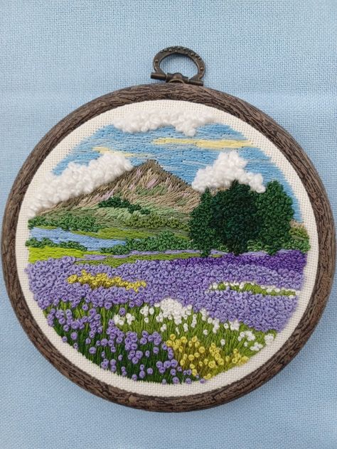 Detailed and textured handstitched embroidery landscape. Lavender flowers/mountain view/fluffy clouds/embroidery art/embroidery decor/gift/ www.Etsy.com/shop/FrenchKnotCreations Landscape Embroidery Ideas, Embroidery Landscape Easy, Mountain Embroidery Pattern, Clouds Embroidery, Mountains Embroidery, Landscape Lavender, Embroidery Water, Cloud Embroidery, Flowers Mountain