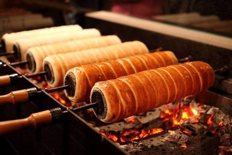 Chimney cakes roasting over an open fire in Budapest, Hungary Chimney Cake Recipe, Chimney Cake, Hungarian Cuisine, Cake Liner, Czech Recipes, Special Desserts, Hungarian Recipes, Polish Recipes, Ice Cream Sandwich