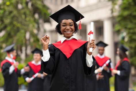 Cheerful african american young lady in graduation costume showing her diploma and smiling at camera, black female student posing over international group of students at university campus, copy space Student Images, Cricut Monogram, Kids Graduation, University Graduation, Graduation Gown, African Print Fashion Dresses, University Campus, Young Black, Graduation Photos