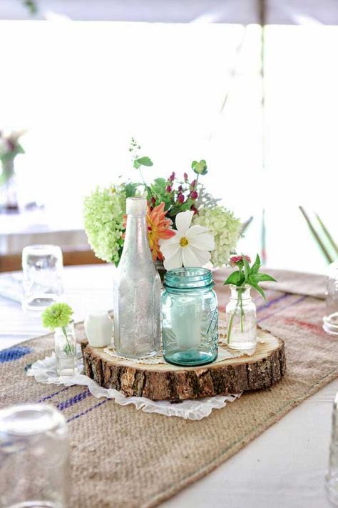 19 Splendid Summer Wedding Centerpiece Ideas That Will Beautify Your Event Blue Mason Jar Centerpieces, Flower Arrangements Diy Artificial, Jar Wedding Decor, Wedding Centerpieces Boho, Centerpieces Boho Wedding, Save The Date Wood, Mason Jar Wedding Decor, Wood Slice Centerpieces, Burgundy Wedding Centerpieces