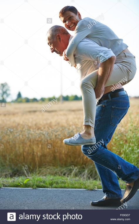 Old man giving woman piggyback ride on his back in summer Stock Photo Piggy Back Ride Reference, Piggyback Reference, Piggyback Ride Reference, Piggy Back Ride Drawing Reference, Piggyback Pose, Man Pushing Rock Uphill, Piggy Back Rides Couples, Ride Drawing, Piggyback Ride