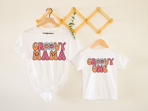 "This \"groovy one\" tee would make the perfect 1st birthday outfit for a \"groovy 1\" party!! Looking for the matching \"groovy mama\" tee? Check out my shop or click the link to take you right to it- https://www.etsy.com/listing/1222858747 *HOW TO ORDER* 1. Look through photos at the different colors and the sizing chart (all shirts & sweatshirts are unisex!) 2. Select your size and color from the drop down menus. 3. Choose the quantity you want in that size and color. 4. If applicable, add yo 2 Groovy, Groovy Birthday Party, Third Birthday Girl, Hippie Birthday Party, Groovy Tees, Groovy Mama, Groovy One, Groovy Shirt, Groovy Birthday