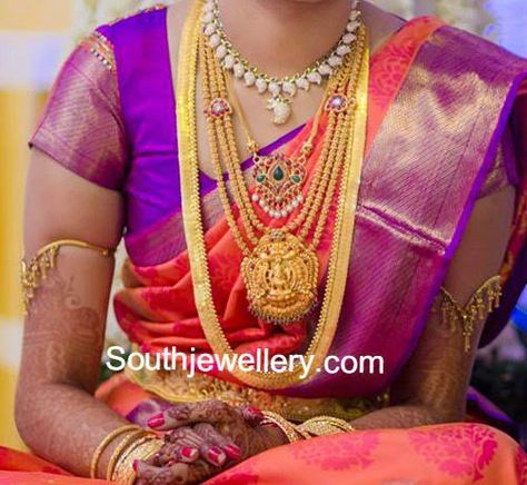 South indian bride adorning a short cz stones mango necklace; a medium length simple gold chain with peacock ruby pendant; three line gold haram with Goddess Lakshmi pendant; long plain kasu haram and simple armlets. Bride Gold Jewellery, Kasu Haram, Telugu Bride, Lakshmi Pendant, Simple Gold Chain, Mango Necklace, Traditional Wedding Jewellery, South Indian Bridal Jewellery, Latest Jewellery Designs