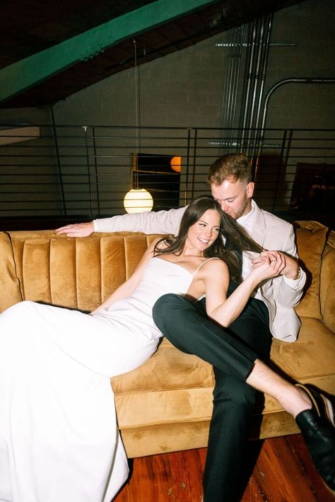 Groom on Couch With Bride in Fitted Gown Laying on Lap, After Party Laying On Lap, Couch Wedding, Monochromatic Wedding, Wedding Shot List, Fitted Gown, Pastel Bouquet, Lay Photo, Wedding Shot, The Guild