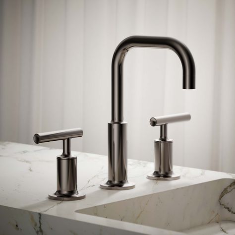 Combining architectural forms with sensual design lines, KOHLER® Purist faucets and accessories bring a touch of modern elegance to your bathroom. This widespread bathroom sink faucet exemplifies the Purist collection's understated style, with its low gooseneck spout and lever handles. Easy-to-install and leak-free UltraGlide® valves provide reliable performance and durability. And the spout features laminar flow, which helps conserve water while preventing splashing. KOHLER Purist Vibrant Titanium Widespread 2-Handle WaterSense Bathroom Sink Faucet with Drain | 14406-4-TT Kohler Purist Bathroom, Nickel Bathroom Faucet, Kohler Bathroom Faucet, Laminar Flow, Kohler Purist, Architectural Forms, Nickel Bathroom, Conserve Water, Understated Style