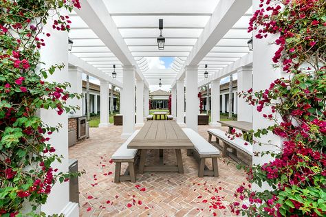 Tucked between the stables, sleep quarters, and clubhouse, this outdoor sitting area is the perfect spot to entertain. Designed by: Alexis Venanzi Equestrian Interior Design, Equestrian Interior, Modern Equestrian, Stable Style, White Pergola, Wellington Florida, Outdoor Sitting, Outdoor Sitting Area, Upscale Furniture