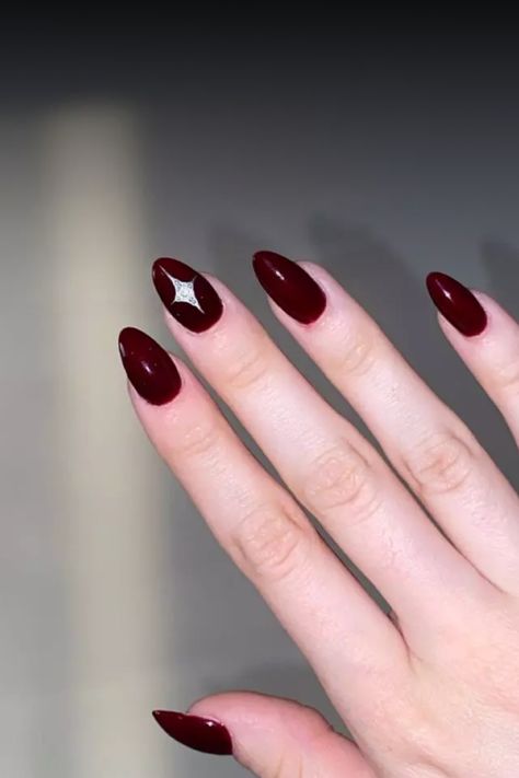 Achieve an elegant look with this glamorous dark red almond manicure. The deep red hue adds a touch of sophistication to your nails, perfect for any occasion. The unique almond shape creates a sleek and modern finish, making this manicure a standout choice for those who love luxurious style. Treat yourself to bold and beautiful nails with this stunning dark red almond manicure today! Nail Art Maroon Simple, Nail Art Maroon, Almond Manicure, Maroon Nail Art, Maroon Nails, Classic Nails, Almond Shape, Popular Nails, Bold And Beautiful