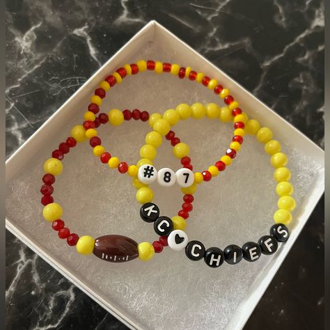 Handmade Kansas City Chiefs Friendship Bracelet Set. Calling All Chiefs Fans And Swifites!!!!! Show Your Support With This Adorable Bracelet Set! Set Comes With 3 Bracelets! One Is A Red And Yellow Beaded Bracelet With A Football Charm, One Is A Red And Yellow Bracelet With #87 For Kelce And Last But Not Least Is The Plain Yellow Beaded Bracelet That Says Kcchiefs. Kc Chiefs Beaded Bracelet, Kc Chiefs Bracelet, Chiefs Friendship Bracelet, Chiefs Bracelet Ideas, Chiefs Bracelet, Kansas City Chiefs Jewelry, Vintage Gold Cuff Bracelet, Swiftie Bracelets, Yellow Beaded Bracelet