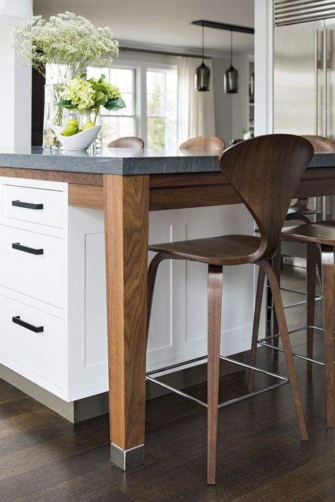 This two-toned kitchen island is both white and walnut, with black hardware in the mix.  The tapered leg detail on the walnut leg gives a table leg effect, and the drawers in the overhang offer hidden storage for placemats.  The Cherner chairs from Design WIthin Reach are walnut plywood.  The mix of contemporary and traditional in this kitchen gives a vibe of casual luxury! Kitchen inspiration can come in the form of these small details, like the metal feet on the island leg. #studiodearborn Kitchen Island With Legs, Studio Dearborn, Kitchen Island Legs, Lake Kitchen, Kitchen Peninsula, Kitchen New York, Westchester Ny, Two Tone Kitchen, Island Dining