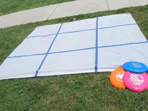 Frisbee Tic Tac Toe  Get a shower curtain from Dollar Tree and we use cheap tape to make a Tic Tac Toe grid.  Set 6 frisbees out and have the kids stand behind a line and see who had the best aim!  Would be so easy to incorporate core subjects-! Outside Games, Reunion Games, Fun Outdoor Games, Yard Games, Backyard Games, Carnival Games, Camping Games, Field Day, Camping Ideas