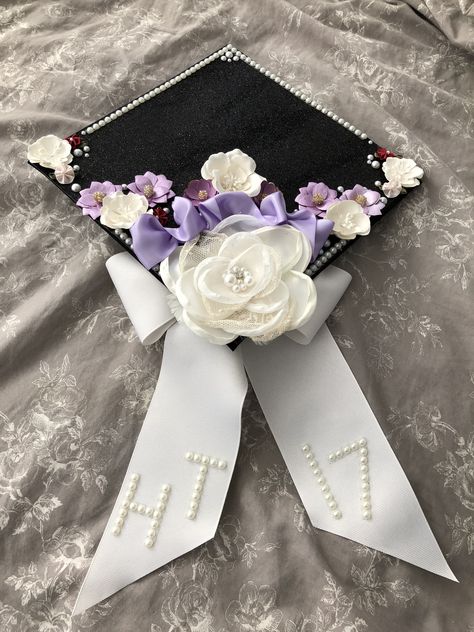 Daughter’s graduation cap Guyanese Graduation Cap, Decorative Graduation Caps, Graduation Cap Designs Simple Flowers, Flower Cap Decoration Graduation, Simple Cap Designs, Graduation Cap Decoration Flowers, Purple Cap Decoration Graduation, Tvd Graduation Cap Ideas, Graduation Cap Designs Coquette