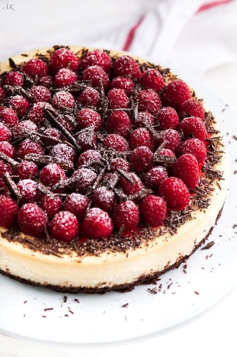 Dark Chocolate Raspberry Cheesecake Cake Recipes Raspberry, Wedding Cheesecakes, Wedding Cheesecake, Dark Chocolate Raspberry, Chocolate Raspberry Cheesecake, Chocolate Crust, Raspberry Sauce, Raspberry Cheesecake, Chocolate Shavings