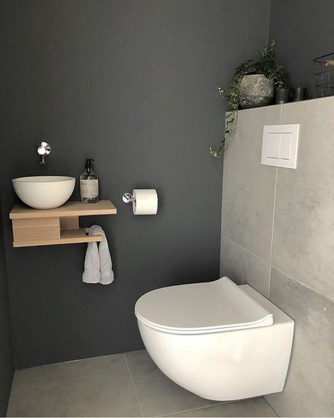 a tiny guest toilet with stone tiles, a wall-mounted wooden vanity with a vessel sink and a potted plant - DigsDigs Small Toilet Design, Wc Ideas, Toilette Design, Wc Design, Small Toilet Room, Downstairs Loo, Guest Toilet, Downstairs Toilet, Toilet Room