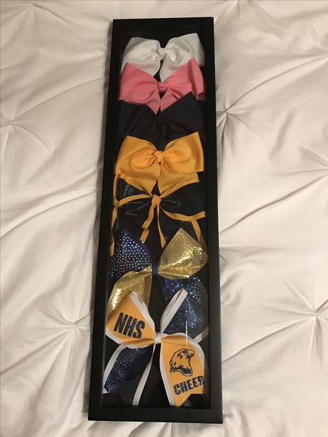 Display Cheer Bows, Cheer Bow Organizer, Cheer Uniform Display Ideas, Cheer Bow Display Graduation, Cheer Showcase Ideas, Cheer Bow Shadow Box Ideas, Cheer Bow Display Ideas, Cheer Display Ideas, Cheer Uniform Shadow Box Ideas