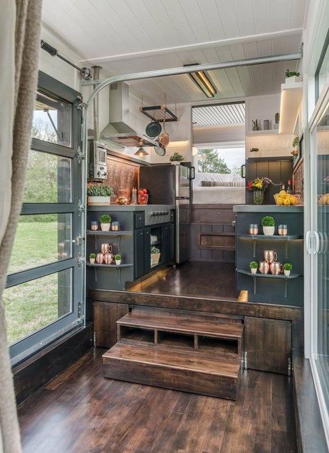 The kitchen sits on top of a raised platform and a nested dining set pulls out from under the platform to accommodate up to 12 people. The owners love to entertain! Tiny House Kitchen Storage, Gooseneck Tiny House, Wohne Im Tiny House, Casa Loft, Diy Tiny House, Tiny House Interior Design, Best Tiny House, Tiny House Inspiration, Tiny House Kitchen