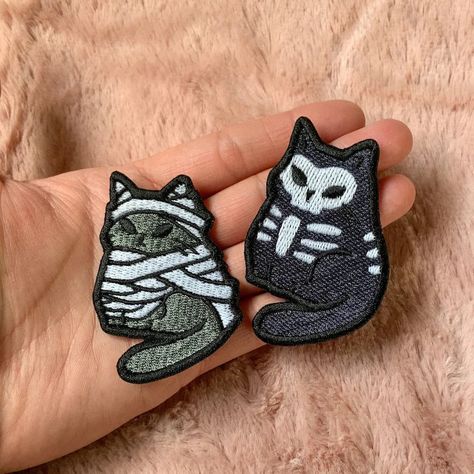 Ghost Cat : 2.5" H x 2.45" W Mummy Cat : 2.5" H x 1.87" W Skeleton Cat : 2.5" H x 1.86" W Machine embroidered on twill Glow in the dark thread glows green when dark. High quality polyester thread Due to differences in lighting on each screen, colors may appear different. Skeleton Cat, Glow In The Dark Halloween, Halloween Kitty, Sew On Badges, Embroidered Backpack, Dark Halloween, Cat Patch, Halloween Cats, Backpack Patches