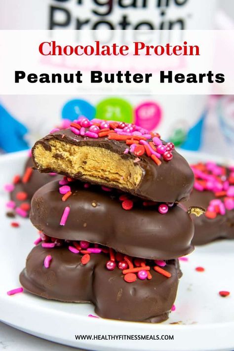 These chocolate-covered peanut butter protein hearts are such a fun healthy treat to make for Valentine's day or any occasion. they are made with simple ingredients, super easy to make, and so delicious. Rich, creamy, and no baking required. #peanutbutterprotein #proteindessert #healthydessert #valentinesdaydessert #peanutbuttercuprecipe via @healthyfitnessmeals High Protein Valentines Treats, Valentines Protein Treats, Protein Reeses Eggs, Peanut Butter Hearts Chocolate Covered, Heart Peanut Butter Cups, Healthy Reese’s Peanut Butter Cups, 1st Phorm, Peanut Butter Cups Recipe, Keto Healthy