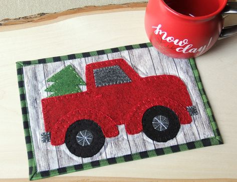 Red Truck Mug Mat FREE Sewing Pattern This red truck mug mat fits right into the farmhouse aesthetic that’s so popular right now. The mat is made using a felt applique technique, so it’s fairly easy and quick to complete. While I love the red truck, you could certainly make … Continue reading → Christmas Mug Rugs, Mug Mat, Mug Rug Patterns, Felt Applique, Christmas Quilts, Christmas Sewing, Mug Rug, Red Truck, Sewing Gifts