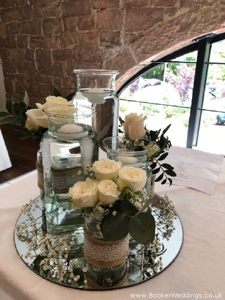 Rustic wedding table centrepiece on mirror plates at Allerton Manor Golf Club #candlesandflowers #mirrorplates #liverpoolflorists -Wedding Flowers Liverpool, Merseyside, Bridal Florist, Booker Flowers and Gifts, Booker Weddings Mirror Center Piece Wedding, Circle Mirror Centerpiece Wedding, Mirror Plate Wedding Centrepieces, Flowers And Mirror Centerpiece, Mirror Tray Wedding Centerpiece, Mirror Table Centerpieces, Mirror Wedding Centerpieces, Wedding Table Centerpieces Rustic, Amazing Wedding Centerpieces