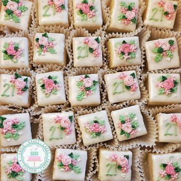 21st birthday petit fours with pink rosettes and flowers Birthday Petit Fours, Wedding Shower Petit Fours, Floral Petit Fours, Pink Petit Fours, Petit Fours Decorations, Wedding Petit Fours, Petit Fours Wedding, Coquette Bachelorette, Petit Fors