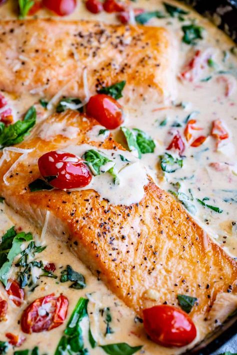 Creamy Tuscan Salmon (30 Minute Dinner!) from The Food Charlatan. This Creamy Tuscan Salmon recipe is totally restaurant quality, but super easy to make! Perfectly pan-seared salmon, drowning in a creamy parmesan sauce with garlic, cherry tomatoes, spinach, and fresh basil. It's the perfect summer meal and is done in 30 minutes! #easy #recipe #summer #garden #salmon #tuscan #creamy #cherrytomato #basil #spinach #parmesan #tomato #30minutedinner #oneskillet #garlic #butter #garlicbutter #pasta Creamy Tuscan Salmon, Salmon Recipe Pan, Tuscan Salmon Recipe, Salmon Dinner Recipes, Tuscan Salmon, Spinach Parmesan, Creamy Salmon, Salsa Tomatillo, Salmon Recipes Pan Seared