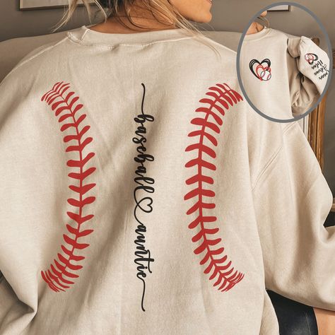 "Introducing our charming Baseball-themed sweatshirt, perfect for proud Baseball \"Aunt\" everywhere! Featuring a unique design with a baseball laces on the back and the phrase baseball Auntie placed down the spine along with the option to personalized with your nephews or niece's' names displayed on the sleeve, this sweatshirt is a true standout. Crafted from a cozy blend of 50% cotton and 50% polyester, this unisex heavy blend crewneck sweatshirt ensures maximum comfort and warmth during colder months. The classic fit and ribbed knit collar offer a comfy, clean-cut style, while double-needle stitching guarantees durability wash after wash. Plus, with no itchy side seams and a tear-away label, it's designed for itch-free wearing. Made with ethically grown US cotton and OEKO-TEX-certified Baseball Shirt Designs, Baseball Sweatshirts, Baseball Stitch, Softball Shirt, Aunt Shirts, Team Mom, Baseball Mom Shirts, Baseball Gifts, Sports Mom