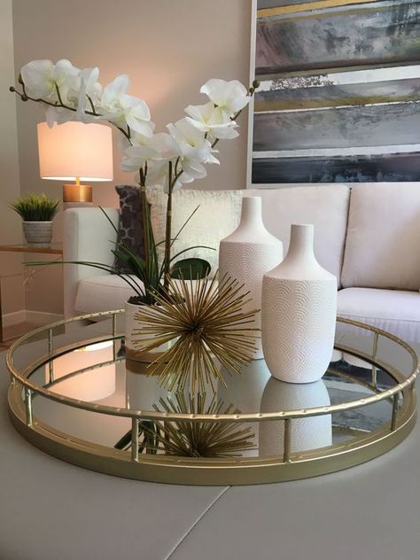 Glass Trays Decoration, Decorative Tray Ideas Dining Table, Gray With Gold Accents Living Room, Glass Tray Decor Living Rooms, Decor Tray Ideas Living Room, Ottoman With Tray On Top Decor, Decorative Ottoman Tray Ideas, Ottoman Centerpiece Ideas, Gold Tray Decor Living Room