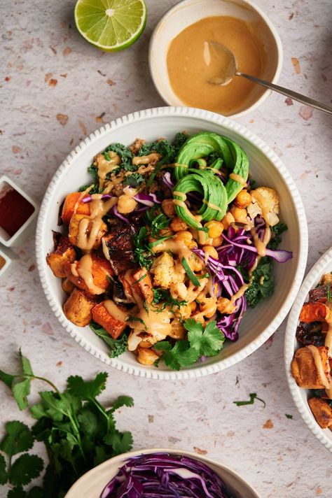 This easy Buddha bowl recipe is hearty, nutritious, and comforting! It’s packed with roasted sweet potatoes, chickpeas, and cauliflower served with quinoa and tons of veggies. All tossed with an irresistible maple tahini sauce. Serve this vegan and gluten-free recipe for a filling lunch or gourmet dinner. #lunch #bowl #makeahead #quickandeasy #grainbowl #buddhabowls Buddha Bowl Sauce, Buddha Bowl Recipe, Korean Beef Bowl, Buddha Bowls Recipe, Slender Kitchen, Filling Lunch, Sushi Bowl, Gourmet Dinner, Tahini Sauce