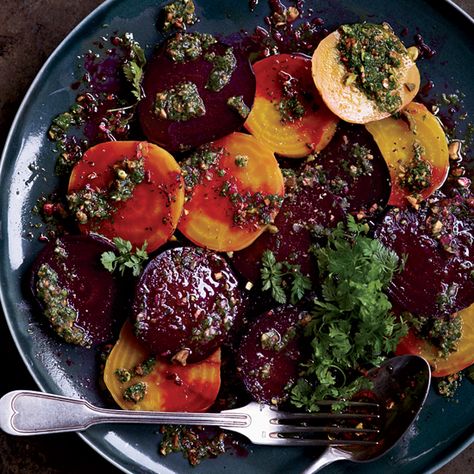 Roasted Beets with Pistachios, Herbs and Orange | Beets are a no-brainer for healthy meals since they taste great even when they’re simply roasted with a little oil. Naomi Pomeroy goes beyond that, topping red and golden beet slices with a lively mixed-herb dressing, pistachios and celery leaves. Beets Roasted, Celery Leaves, Orange Recipe, Beets Carrots, Herb Dressing, Orange Food, Thanksgiving Salad, Vegan Thanksgiving, Roasted Beets