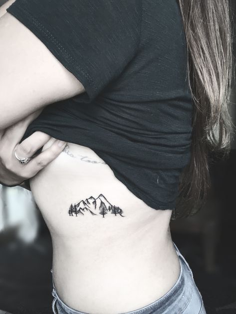 Dainty black mountain tattoo on ribs Moutain Tattoos, Small Geometric Tattoo, Small Rib Tattoos, Rib Tattoos For Women, Mountains And Trees, Beautiful Flower Tattoos, Triangle Tattoos, Muster Tattoos, Arrow Tattoos