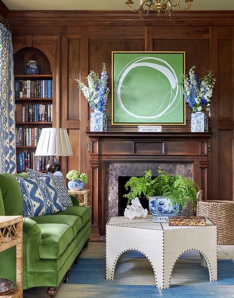 Gorgeous wood paneled den features a green velvet roll arm sofa on caster legs flanked by windows dressed in white and blue curtains facing a burlap hexagon cocktail table accented with brass nailhead trim placed atop a cream and blue rug. Paneled Library, Living Room Green, Green Rooms, Newport Beach, A Living Room, Green Living, Traditional House, Wood Paneling, The Wall