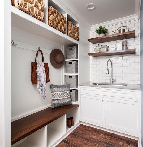 Two-toned mudroom/laundry room design featuring a white built-in mudroom bench with upper cubbies fitted with seagrass bins over a darkly stained bench and open shelves. Mudroom With Sink, Hallway Shoe Storage, Laundry Room Storage Shelves, Small Laundry Room Organization, Stylish Laundry Room, Room Bench, Mudroom Laundry Room, Floating Shelves Bathroom, Elegant Interior Design