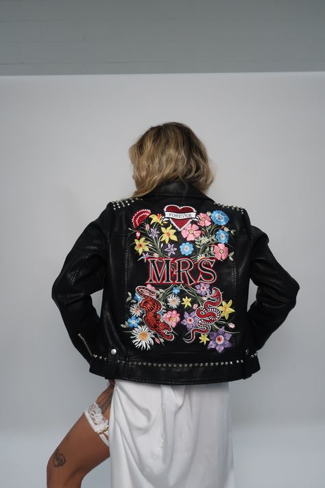 The ULTIMATE jacket for all punk rocker brides out there. Taking over 12 hours to produce using advanced digital embroidery techniques with hand studded details to finish. This exclusive Beth Wilson Bespoke Embroidery jacket includes 25 thread colours, 4 appliqué patches and over 268,000 stitches. Full design measures 28.5cm W x 41cm H, will be adapted to best compliment jacket size. Model is a UK 6 and wears a UK 14. ❤️ LOVE this design but it's not on the correct size or style of jacket for yo Rocker Bride, Embroidery Jacket, Bride Fashion, Alternative Bride, Bridal Jacket, Wedding Jacket, Punk Rocker, Jacket Denim, Faux Leather Jacket