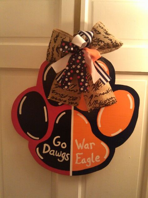 House divided paw. Georgia Bulldogs and Auburn Tigers. Can do any team you want. Get yours for football season. Starting at $30. Tiger Paw, Tiger Football, Geaux Tigers, Wooden Door Hangers, Classroom Door, Auburn Tigers, Door Hanger, Door Hangers, Auburn