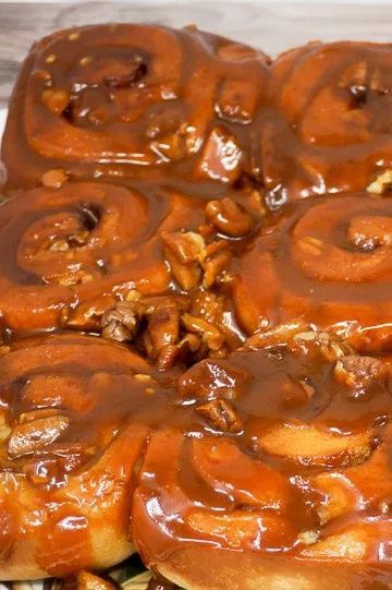 Sticky Puppies are caramel pecan sticky buns that are made with frozen cinnamon rolls and homemade buttery caramel sauce. By using quick-rise rolls, you can make these delicious Caramel Cinnamon Rolls in about 30 minutes. Time to eat! | Caramel Pecan Cinnamon Rolls | butterscotch cinnamon rolls | butterscotch pudding rolls | caramel sticky rolls | Caramel Cinnamon Rolls | Caramel Breakfast Rolls | #breakfast #brunch #sweets #caramel #cinnamonrolls Pecan Cinnamon Rolls Recipe, Frozen Cinnamon Rolls, Caramel Pecan Cinnamon Rolls, Maple Bacon Cinnamon Rolls, Caramel Cinnamon Rolls, Rhodes Cinnamon Rolls, Caramel Pecan Sticky Buns, Easy Sticky Buns, Caramel Sticky Buns