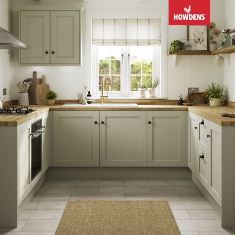 Introducing the stunning Howdens Halesworth Sage Green Kitchen. Perfect for traditional kitchen designs, these shaker-style green kitchen cabinets add a touch of elegance to any space. Pair them with oak kitchen countertops for a cohesive look that's both timeless and practical. The U-shaped kitchen design offers ample storage and workspace, making it perfect for busy families and home chefs. Trust us, this kitchen is a stylish and functional choice that you won't regret. Kitchen Floor With Green Cabinets, Light Sage Kitchen, Light Sage Kitchen Cabinets, Sage Green Kitchen Cabinets, Green Shaker Kitchen, Open Shelving Kitchen, Light Green Kitchen, Green Kitchen Island, Howdens Kitchens