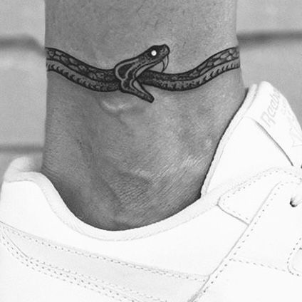 Snake Tattoos Around Ankle, Tattoo Ideas For Men Elbow, Simple Above The Knee Tattoo Men, Knee Tatoos Men, Ouroboros Tattoo Ankle, Ankle Tattoo Men Wrap Around, Small Snake Tattoo Men, Men’s Shin Tattoo, Under Knee Tattoo Men