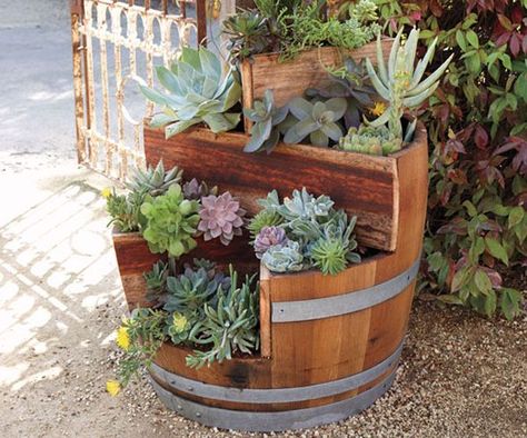 19 Interesting Ways Of Using Wine Barrels In Home Décor    http://www.homedit.com/19-interesting-ways-of-using-wine-barrels-in-home-decor/ Wine Barrel Garden, Wood Barrel Planters, Barrel Flowers, Wine Barrel Planter, Wine Barrel Ideas, Barrel Projects, Patio Plans, Tiered Planter, Wine Barrel Furniture