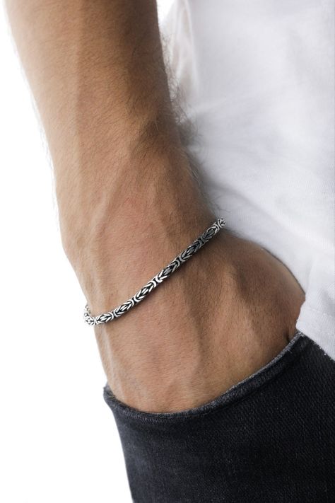 Indulge in the craftsmanship of the 925 Sterling Silver King Chain Bracelet, a harmonious blend of tradition and modern design. Sculpted meticulously from genuine silver, this bracelet showcases the intricate patterns of the Byzantine style, characterized by its handmade square chain links. While its rich history is evident in every detail, its minimalist design aligns seamlessly with contemporary fashion, making it an impeccable choice for today's man. Bracelet Stands, Silver Bracelet Designs, Silver King, Silver Chain For Men, Mens Bracelet Silver, Silver Chains, Jewelry For Men, Chain Links, Silver Chain Bracelet