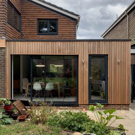 A contemporary rear extension clad in cedar, opening up a kitchen/dining/family room and making a new utility. Designed by BBD Architects Wood Cladding Extension, Kitchen In Extension, Wood Clad House Exterior, Cladding Extension Ideas, Rear Extension Cladding, Bungalow Rear Extension, Wood House Extension, Cedar Clad Extension, Rear House Design